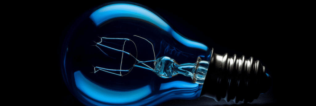 electric blue lightbulb on a black background